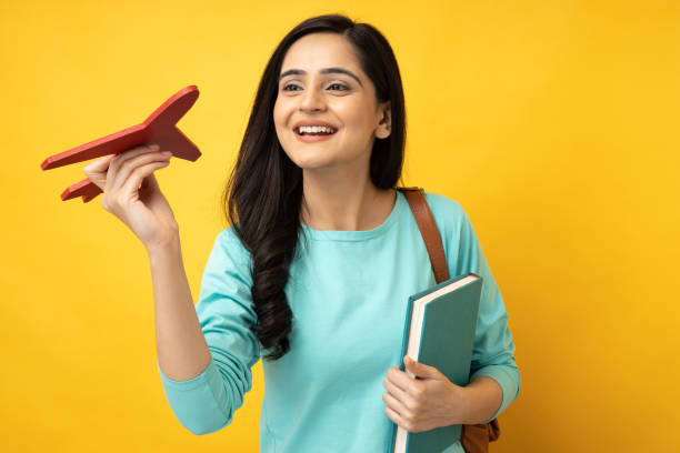 photo of young girl wearing t shirt isolated yellow background